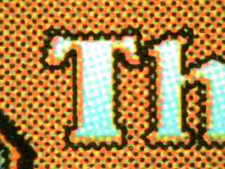 The MTG "T" teeth test under macro magnification, showing a crisp, smooth left edge with no jagged teeth